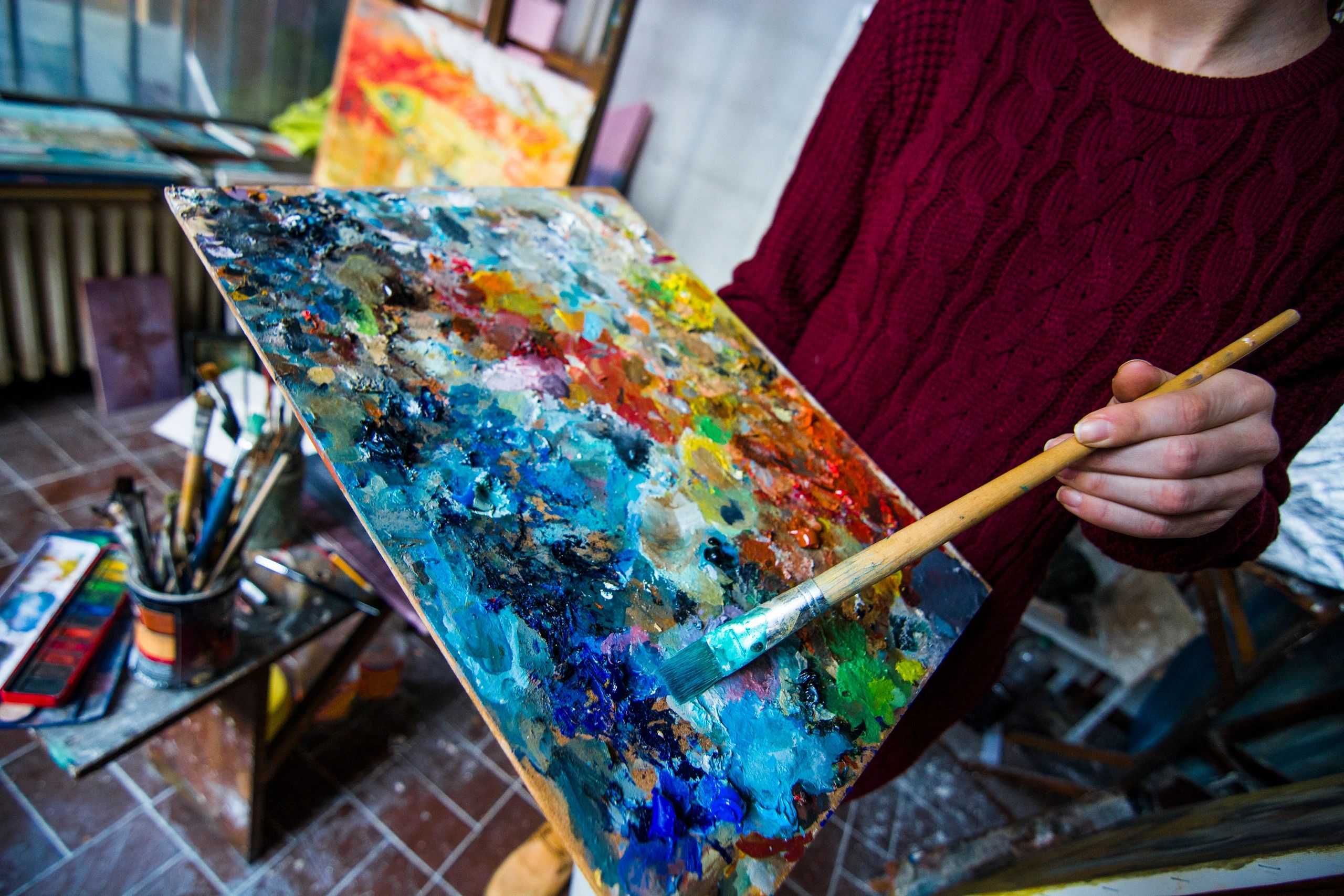 Portrait of a smiling artist in a studio